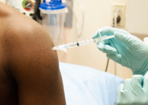 © NIAID | Participant of a clinical trial is injected in the arm with an active drug. © NIAID under Creative Commons Attribution License